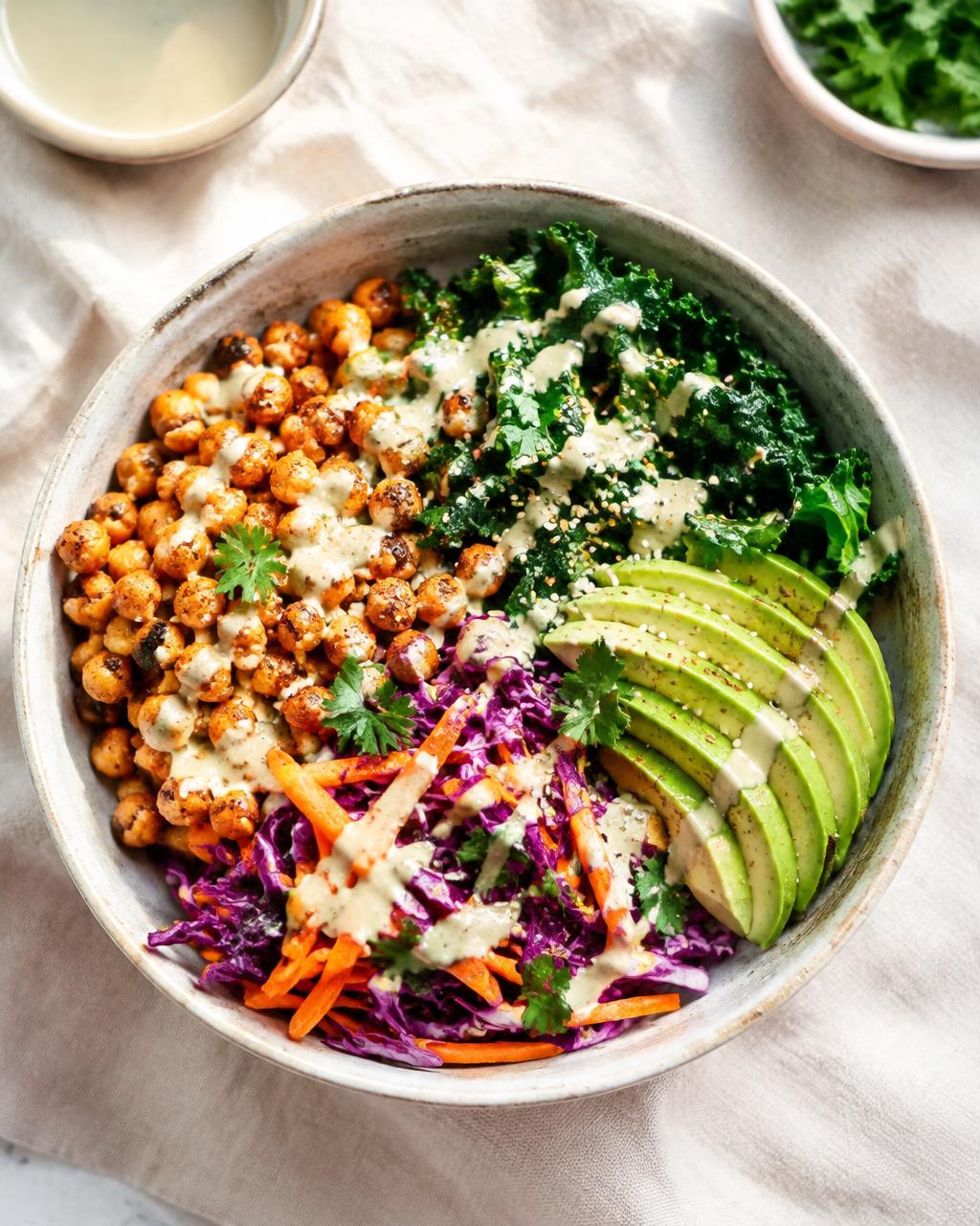 Vegan bowl with chickpeas, kale, avocado and tahini